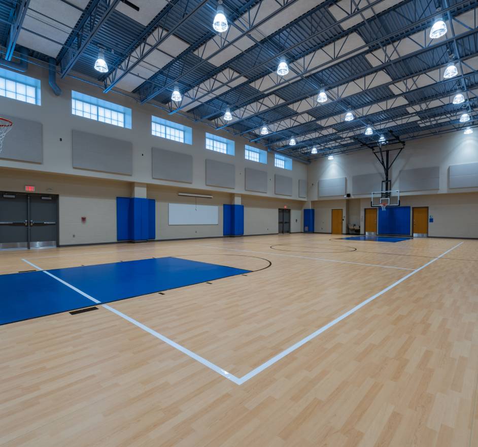 A large gym with many blue lights and white walls.