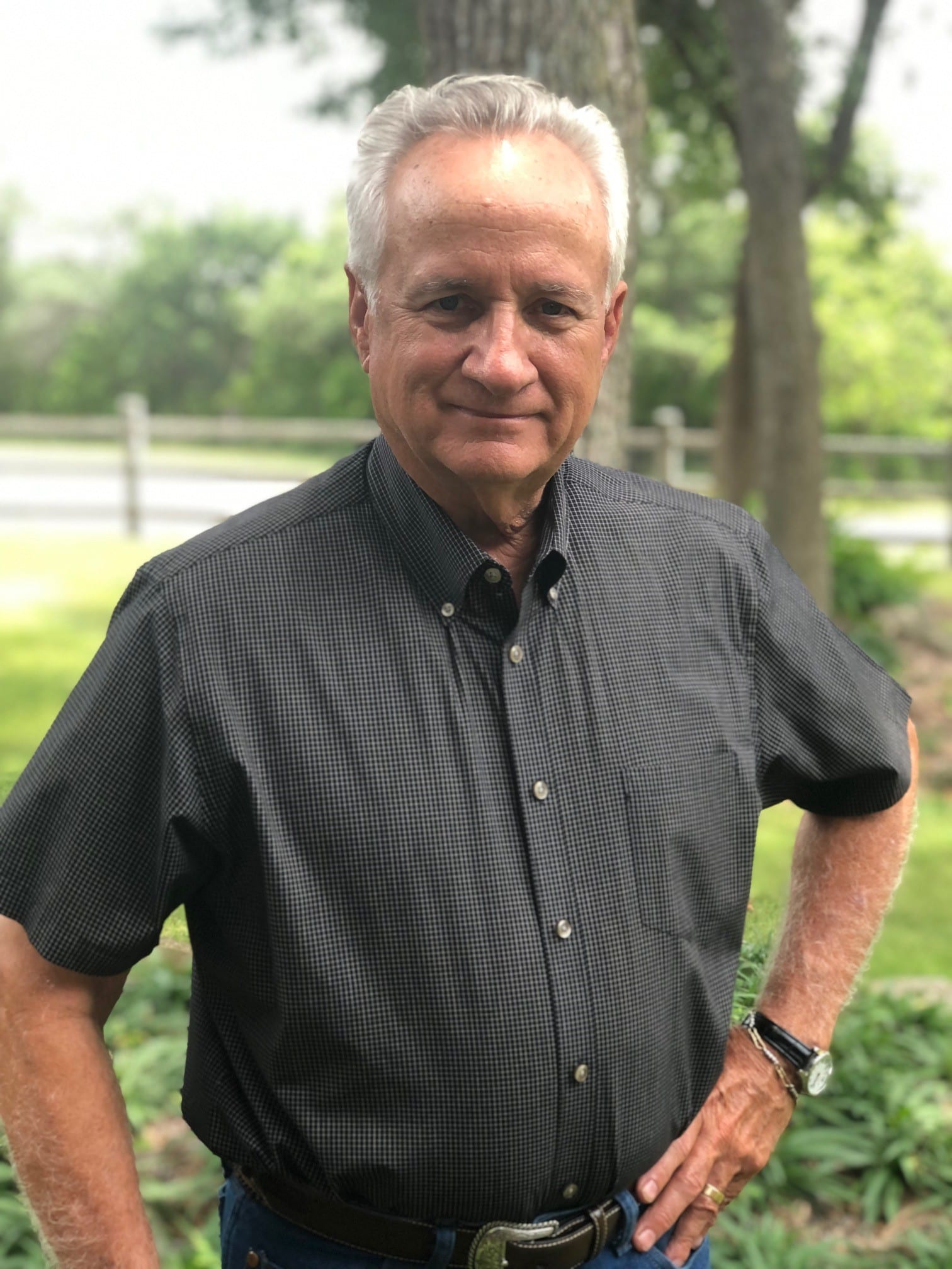 A man standing in front of some trees