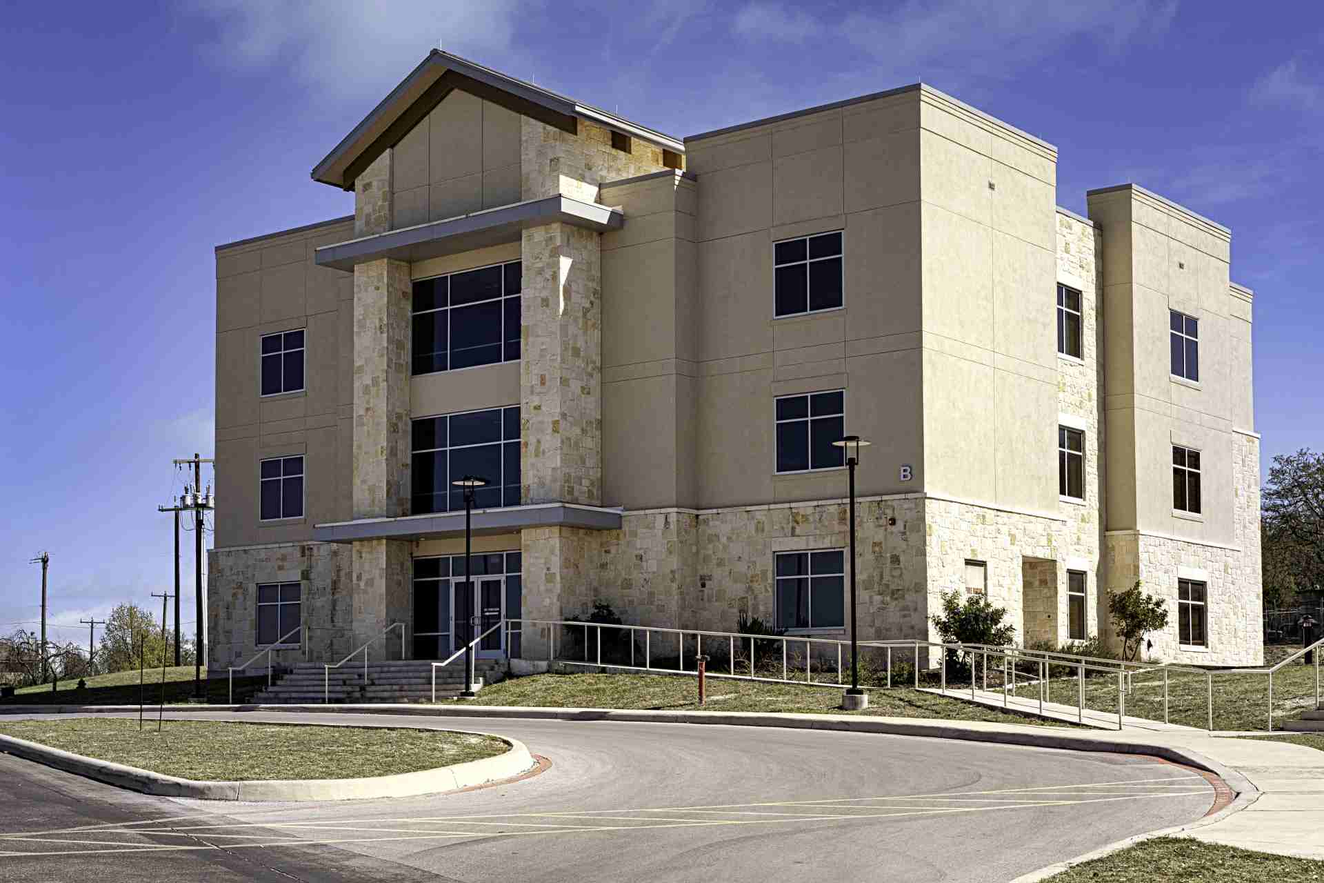 A large building with a parking lot in front of it.