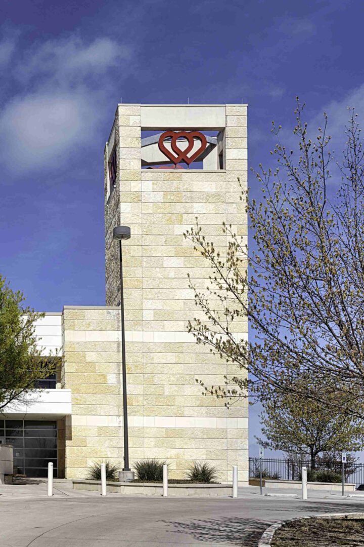 A large stone building with a clock on the top of it.